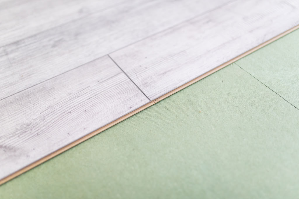 bright laminated flooring boards on gray background